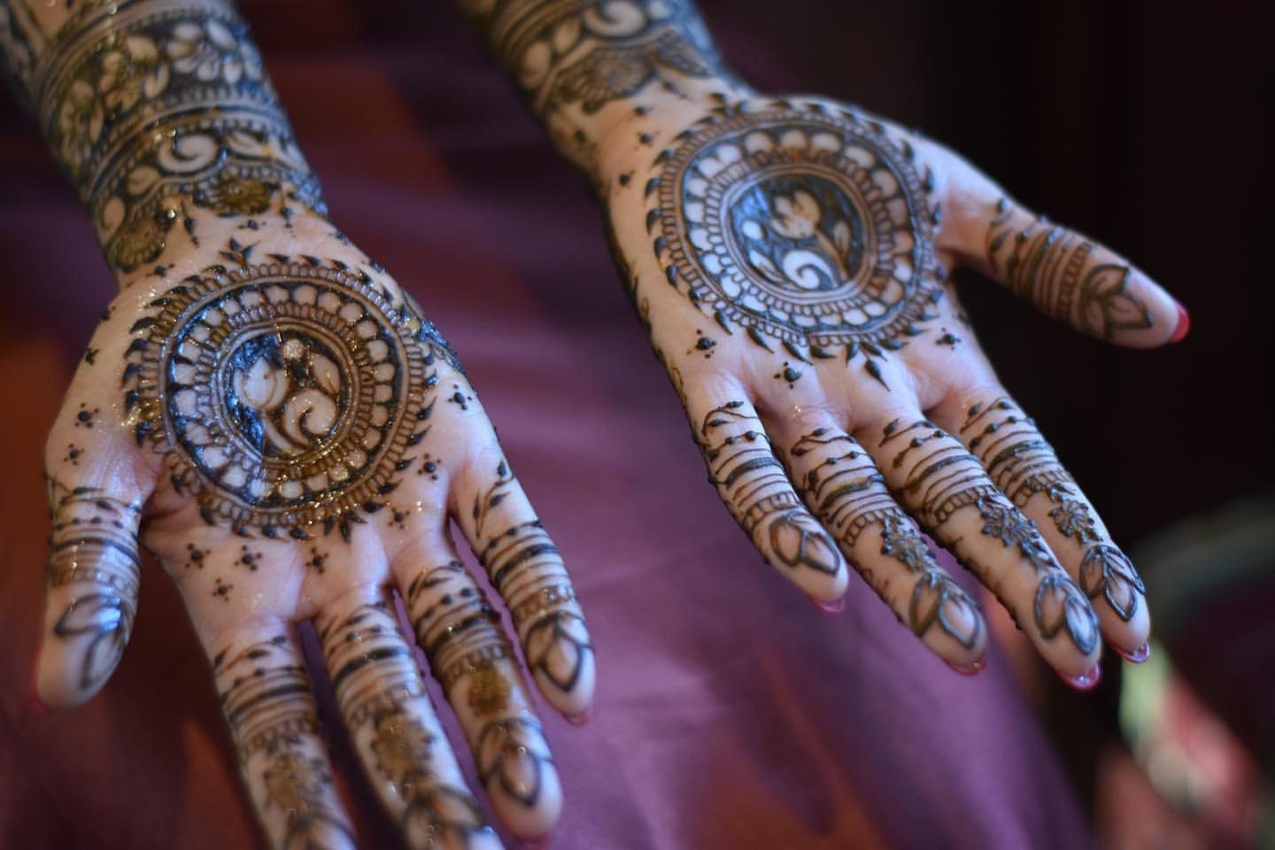 Fresh bridal henna on open palms